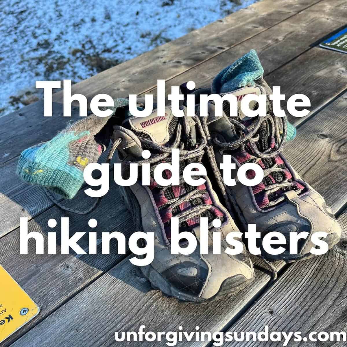 This is the title image. A pair of hiking boots is sitting on a picnic table. The words "the ultimate guide to hiking blisters" is overlaid on the image.
