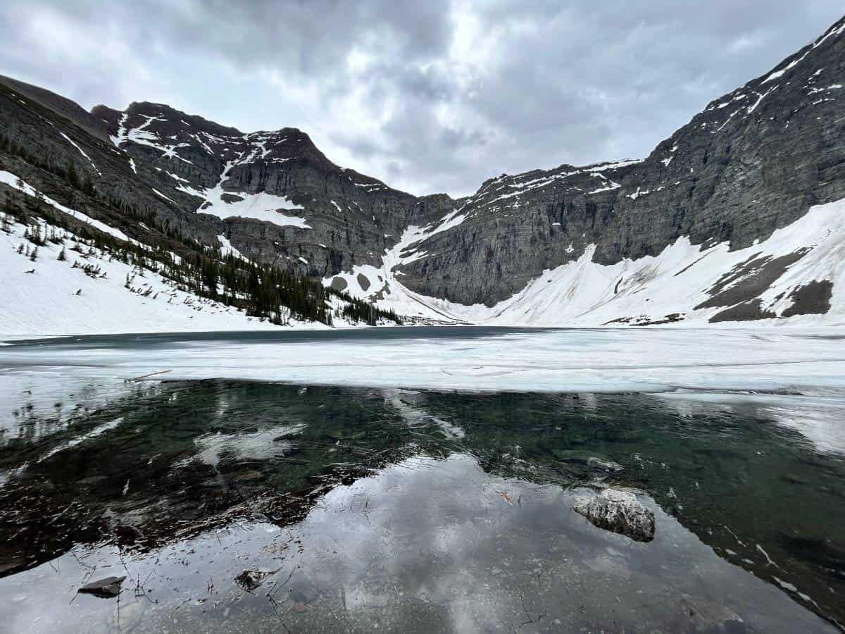 Crypt Lake in the snow with mountains in the background, in Waterton National Park.